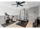 Well-equipped home gym with weight rack and exercise bike at 9489 Ashbury Cir # 202, Parker, CO 80134