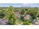 Charming Denver home with mature trees, a white picket fence, and views of the city skyline at 3429 N Adams St, Denver, CO 80205