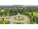 An aerial view of a lush green park with a decorative water fountain and trees at 3429 N Adams St, Denver, CO 80205