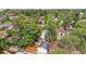 This aerial view shows the home with a detached garage, mature trees and a well-kept backyard at 3429 N Adams St, Denver, CO 80205
