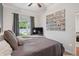 Cozy bedroom with ceiling fan, neutral decor, and window at 3429 N Adams St, Denver, CO 80205