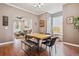 Open dining space with wood flooring, table with seating, and view to living room at 3429 N Adams St, Denver, CO 80205