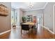 Elegant dining room with wood floors, modern chandelier, and ample natural light at 3429 N Adams St, Denver, CO 80205