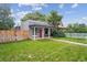 Charming home features a well-manicured lawn, picket fence, and inviting red front door at 3429 N Adams St, Denver, CO 80205