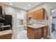 Galley kitchen with stainless appliances, light granite countertops and window at 3429 N Adams St, Denver, CO 80205