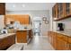 Spacious kitchen with wooden cabinetry, granite countertops, and tiled flooring at 3429 N Adams St, Denver, CO 80205