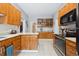 Bright kitchen featuring granite countertops, stainless steel appliances, and plentiful wood cabinetry at 3429 N Adams St, Denver, CO 80205
