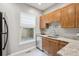 Galley style kitchen with stainless appliances, granite countertops and window at 3429 N Adams St, Denver, CO 80205
