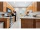 Kitchen with stainless appliances, light granite countertops and wood cabinetry at 3429 N Adams St, Denver, CO 80205