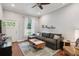 Comfortable living room with couch, natural light, wood floors, and open floor plan at 3429 N Adams St, Denver, CO 80205