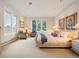 Serene bedroom with neutral colors, cozy seating area, and carpet flooring at 15895 W Bayaud Dr, Golden, CO 80401