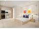 Neutral bedroom with kitchenette, art, and minimalist furniture at 15895 W Bayaud Dr, Golden, CO 80401