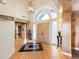 Grand foyer with high ceilings, chandelier, light hardwood floors and large custom double doors at 15895 W Bayaud Dr, Golden, CO 80401