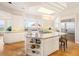 Well-lit kitchen featuring a large island with bar seating, stainless steel appliances, and scenic views at 15895 W Bayaud Dr, Golden, CO 80401