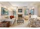 Cozy living room with fireplace, neutral tones, and recessed lighting at 15895 W Bayaud Dr, Golden, CO 80401