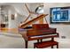 Elegant living room with grand piano, staircase and picture frame molding at 15895 W Bayaud Dr, Golden, CO 80401