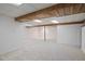 Large basement with carpeted floors and paneled ceiling at 9910 Winona St, Westminster, CO 80031