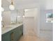 Bathroom featuring a modern vanity with double sinks, a large mirror, and a walk-in closet at 9910 Winona St, Westminster, CO 80031