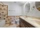 Bathroom showcasing a double sink vanity, tile flooring, and a tiled shower tub at 9910 Winona St, Westminster, CO 80031
