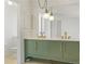 Bathroom with a double sink vanity with pendant lights, a large mirror, and view to the toilet at 9910 Winona St, Westminster, CO 80031