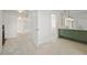 Hallway leading to a full bathroom, featuring carpet, neutral paint and white doors at 9910 Winona St, Westminster, CO 80031