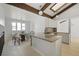 Bright eat-in kitchen with granite counters, wood beams, modern lighting and a mosaic tile backsplash at 9910 Winona St, Westminster, CO 80031