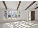 Bright living room featuring large windows, exposed beams and light hardwood flooring at 9910 Winona St, Westminster, CO 80031