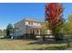 A tan, two-story home with a rustic wood fence enclosing a large backyard, enhancing privacy and charm at 3480 Spruce Dell Ct, Castle Rock, CO 80109