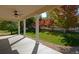 Covered back porch overlooking a large yard with mature trees at 3480 Spruce Dell Ct, Castle Rock, CO 80109