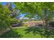 Lush backyard showcasing a fenced-off view of nature behind a beautifully kept green lawn at 3480 Spruce Dell Ct, Castle Rock, CO 80109