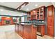 Basement features a wet bar with wood cabinets, granite countertop, stainless fridge and nearby fireplace at 3480 Spruce Dell Ct, Castle Rock, CO 80109
