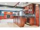 Basement wet bar with granite countertops, wood cabinets, stainless steel beverage fridge and nearby fireplace at 3480 Spruce Dell Ct, Castle Rock, CO 80109