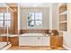 Relaxing bathroom showcases a tub, glass shower, wood-look floors, and shelving at 3480 Spruce Dell Ct, Castle Rock, CO 80109