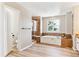 Beautiful bathroom features a tub, glass-enclosed shower, and wood-look floors at 3480 Spruce Dell Ct, Castle Rock, CO 80109