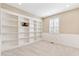 Carpeted room with neutral walls, built-in shelves, and natural light at 3480 Spruce Dell Ct, Castle Rock, CO 80109