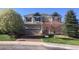 Charming two-story home with a manicured lawn and mature trees at 3480 Spruce Dell Ct, Castle Rock, CO 80109