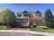 Charming two-story home with a two-car garage and mature trees in the front yard at 3480 Spruce Dell Ct, Castle Rock, CO 80109
