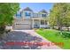 Inviting two-story home features a charming front porch, attached garage, and well-manicured lawn at 3480 Spruce Dell Ct, Castle Rock, CO 80109