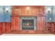 Wood trim fireplace with dark grey stone and decorative mantle at 3480 Spruce Dell Ct, Castle Rock, CO 80109