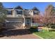 Traditional two-story home with a well-kept lawn, attached garage, and a sign displaying real estate information at 3480 Spruce Dell Ct, Castle Rock, CO 80109