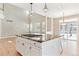 Modern kitchen island featuring a marble countertop and pendant lighting at 3480 Spruce Dell Ct, Castle Rock, CO 80109