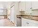 Convenient kitchenette featuring white cabinets, under-cabinet lighting, mini-fridge and stainless-steel sink at 3480 Spruce Dell Ct, Castle Rock, CO 80109