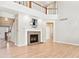 Bright living room with a fireplace, hardwood floors, and an open staircase at 3480 Spruce Dell Ct, Castle Rock, CO 80109