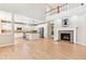 Open-concept space featuring a fireplace, hardwood floors, and a second-floor balcony at 3480 Spruce Dell Ct, Castle Rock, CO 80109