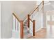 Carpeted staircase with wooden railings and white spindles at 3480 Spruce Dell Ct, Castle Rock, CO 80109