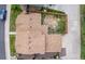Aerial view of a home's roof and fully-fenced backyard featuring partial grass and concrete patio space at 5733 Whitechapel St, Castle Rock, CO 80104