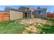 View of the backyard and the back of the house, showing its exterior with glass sliding doors at 5733 Whitechapel St, Castle Rock, CO 80104