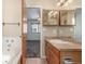 Bathroom featuring a vanity with mirrored medicine cabinets and neutral color palette at 5733 Whitechapel St, Castle Rock, CO 80104