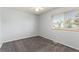 Clean, well-lit bedroom with neutral carpet and view of houses through a window at 5733 Whitechapel St, Castle Rock, CO 80104