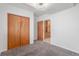Bedroom featuring plush carpet, closet and doorway with wood trim at 5733 Whitechapel St, Castle Rock, CO 80104